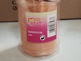 a jar of confettis sitting on a table next to a cardboard box