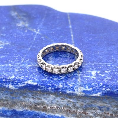 a close up of a ring on a rock with a blue background