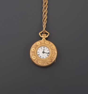 an antique gold pocket watch with a chain on a black background