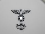 a white plate with a black eagle on it