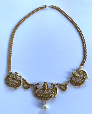 a close up of a necklace on a white surface