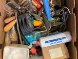 a cardboard box filled with tools and other items