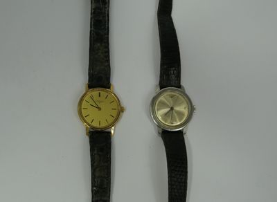 a couple of watches sitting next to each other on top of a table