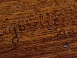 a close up of a piece of wood with writing on it