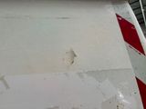 a red and white stripe on the side of a plane