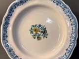 a white plate with a blue and yellow design on it