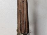 a wooden stick with a metal handle and a wooden handle