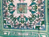 an image of a green and white scarf with a picture of animals on it