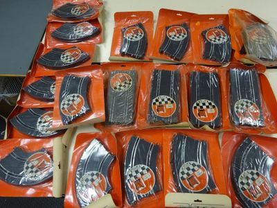 many bags of orange and black items on a table