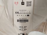 the back of a white shirt with a label on it