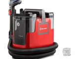 the vacuum is red and black with a black hose and a clear cup
