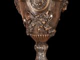 a silver vase that is sitting on a table