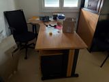 a desk with a chair and a computer on it