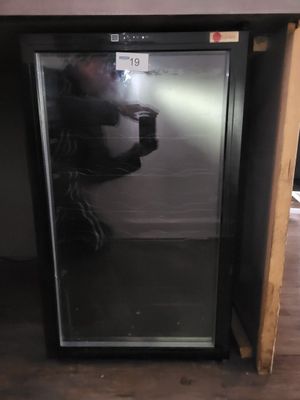 a man taking a picture of himself in the mirror of a refrigerator