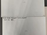 two pieces of paper with writing on them sitting on top of a table