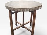 a round table with a metal top and wooden legs