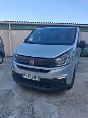 fiat fiorin van parked in a parking lot next to other cars