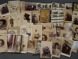 a lot of old photos of people on the table