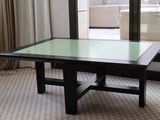 a table with a glass top in front of a window