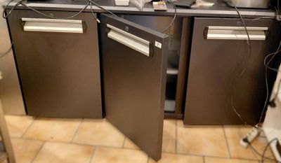 a picture of a kitchen with two refrigerators and a dishwasher