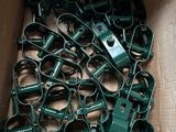 a box full of green wire clamps in it