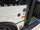 a white bus that is parked on the side of the street