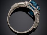 a close up of a ring with a blue stone and diamonds