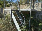 a metal stair going up to the top of a building