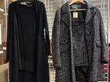 two coats hanging on a wire rack in a store