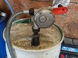 a bucket with a hose attached to it in a garage