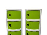two white and green drawers with black dots on them