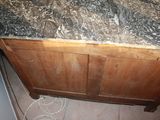 a marble counter top on a wooden cabinet in a kitchen