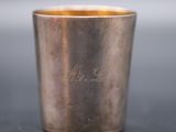 a close up of a silver cup with a name engraved on it