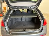 the back of a car with the trunk open in a garage
