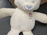 a white teddy bear with a red hat on it ' s head