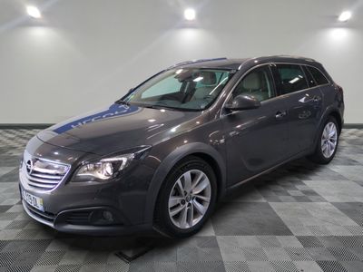 a picture of a grey car parked in a garage