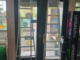 two ladders that are standing in front of a door