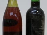 two bottles of wine sitting next to each other on a table