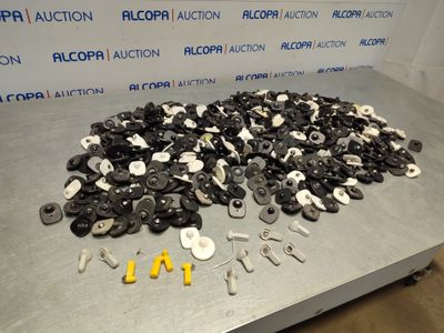 a pile of buttons and screws on a table
