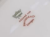 a close up of a white plate with red writing on it