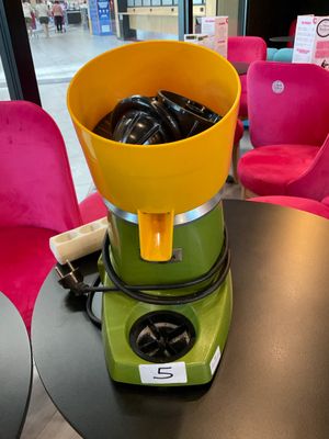 a blender sitting on a table with a bowl on top of it