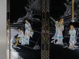 two black and white paintings on the wall of a room