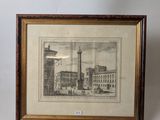 two framed pictures of a building and a clock on a table