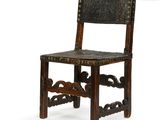 an old wooden chair with a leather seat on a white background