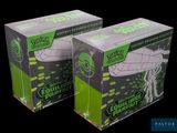 two boxes of green and white paper are sitting on a black surface