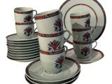a lot of cups and saucers that are sitting on a table