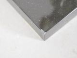 a close up of a piece of metal on a white surface