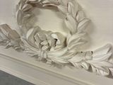a white table with a wreath on top of it
