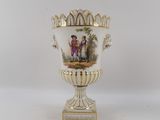 a vase with a painting on it sitting on a table