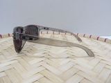 a pair of sunglasses sitting on top of a woven basket